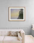 Framed art print of 'Evening Rainbow, Lake Nellim, Finland", shown in an elegant, minimalist room with a classic sofa and a window seat. Displayed here in the size extra-large.
