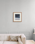 Framed art print of "A Cold Beauty, Lunar Halo" by Nicholas Jones, shown in an elegant, minimalist room with a classic sofa and a window seat. Displayed here in size medium.