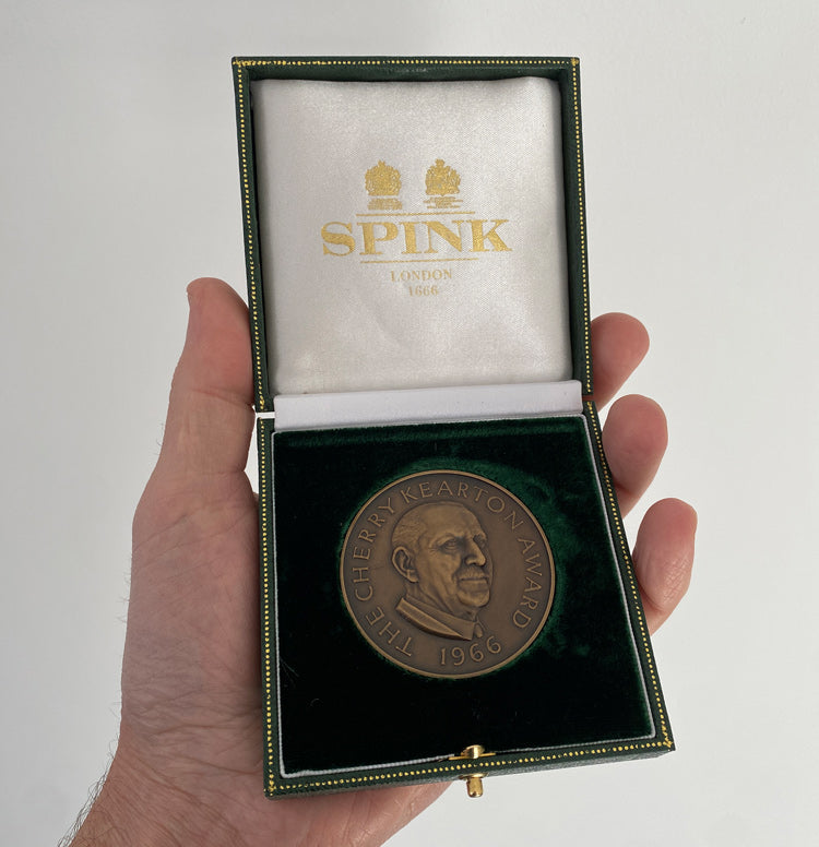The Cherry Kearton Medal and Award received by Nicholas Jones, displayed in its green velvet case and held in his hand.