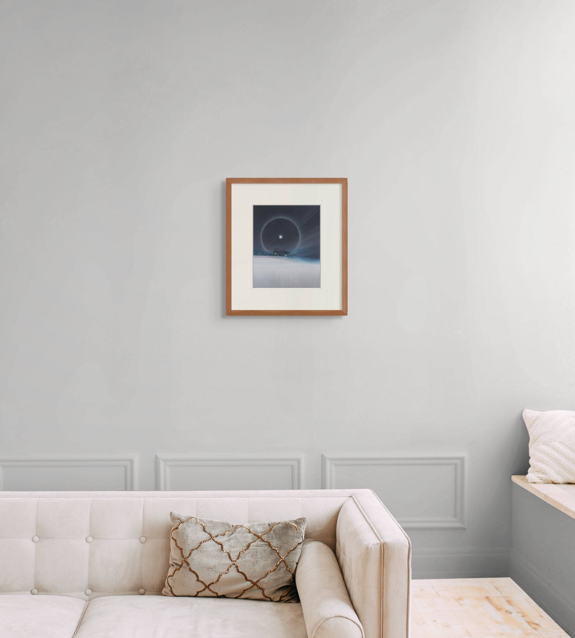 Framed art print of "A Cold Beauty, Lunar Halo" by Nicholas Jones, shown in an elegant, minimalist room with a classic sofa and a window seat. Displayed here in size medium.
